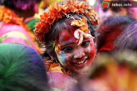 Một em bé với khuôn mặt đầy hạnh phúc sau khi ném phẩm màu tại lễ hội Holi