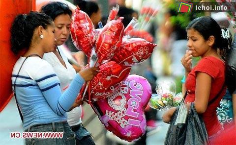 Các cô gái trẻ bán bóng bay hình trái tim trên một con phố tại Tegucigalpa, Honduras . Ảnh: Xinhua. 