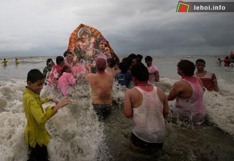 Những tín đồ Hindu đang hất nước vào bức tượng trước khi đưa thần voi ra biển. 